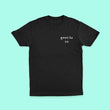 Load image into Gallery viewer, Front of a Gweilo Beer black t-shirt with a small white gweilo logo on the left hand side of the chest. Turquoise pastel background.