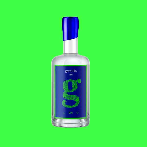 A bottle of Gweilo craft Gin on a bright green background. This delicious citrus forward gin showcases yuzu and mosaic hops.